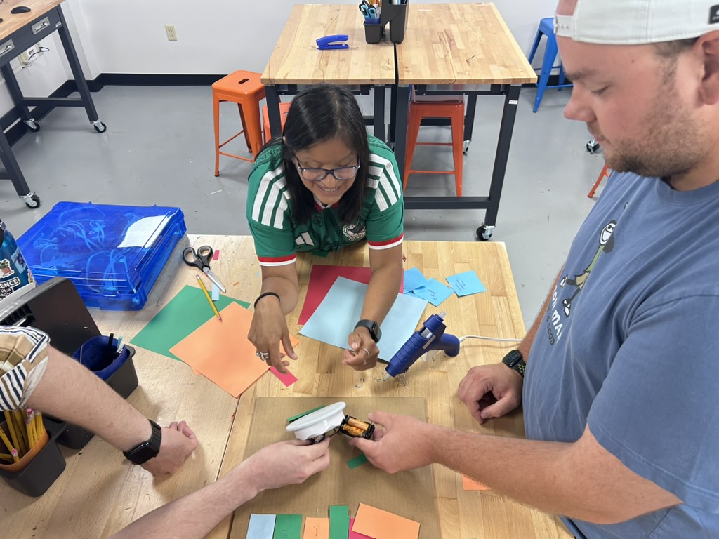 students innovating together at table